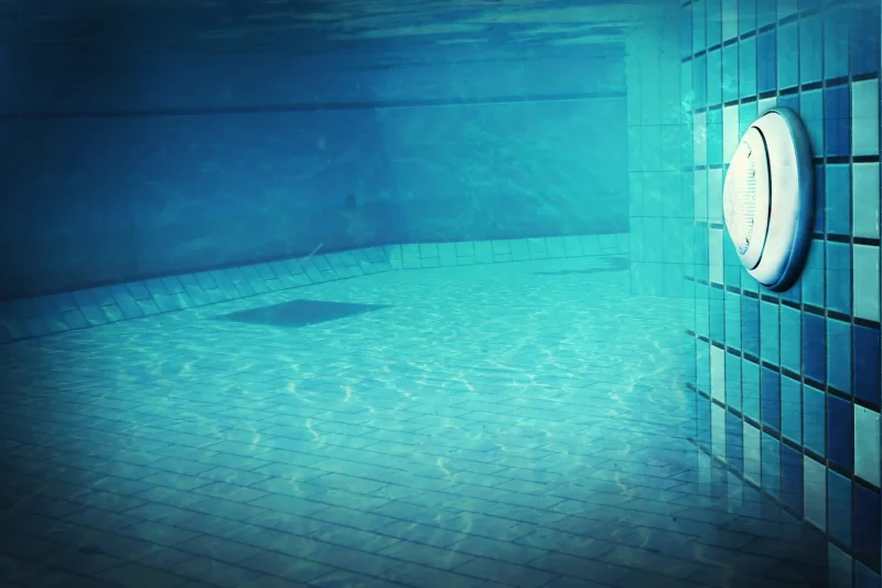Underwater pool light in a wet niche on a tiled pool wall, pool light replacement in Lake Havasu City by JM Pool Service